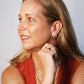 Model wearing Oh Clem earrings, necklaces, rings and bracelets